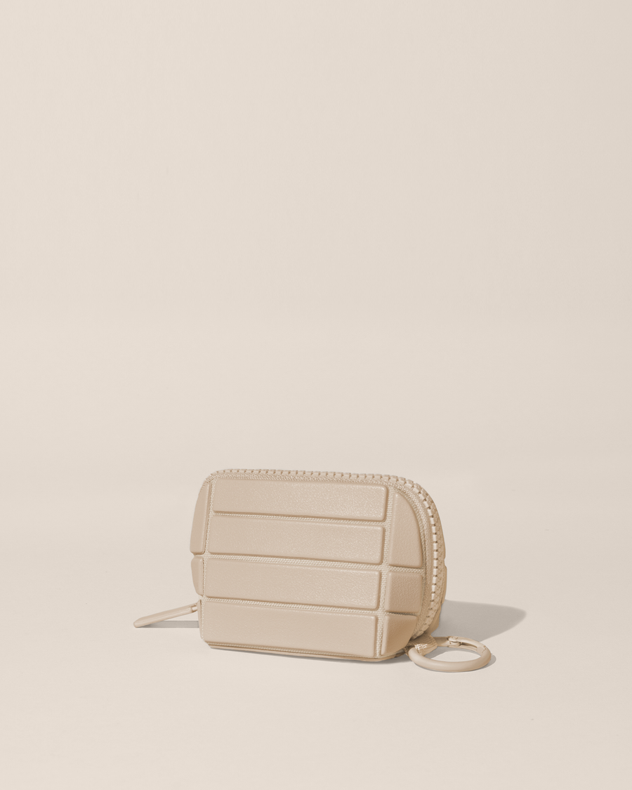 Closed Parallelle Bisque (white) Traveller Keychain with structured horizontal bar design shown from the side