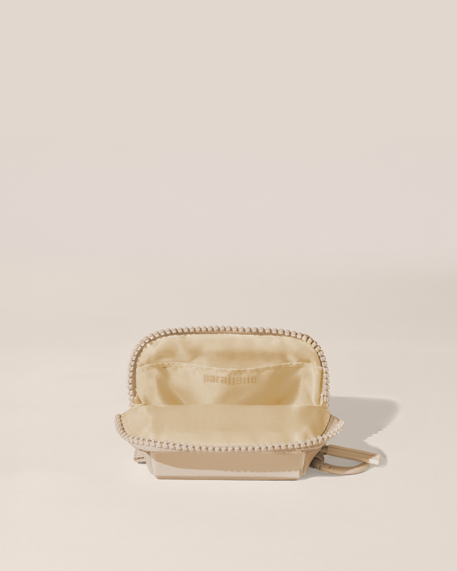 Open view of the Parallelle White (bisque) Traveller Keychain showing the interior, which is perfect for holding small essentials