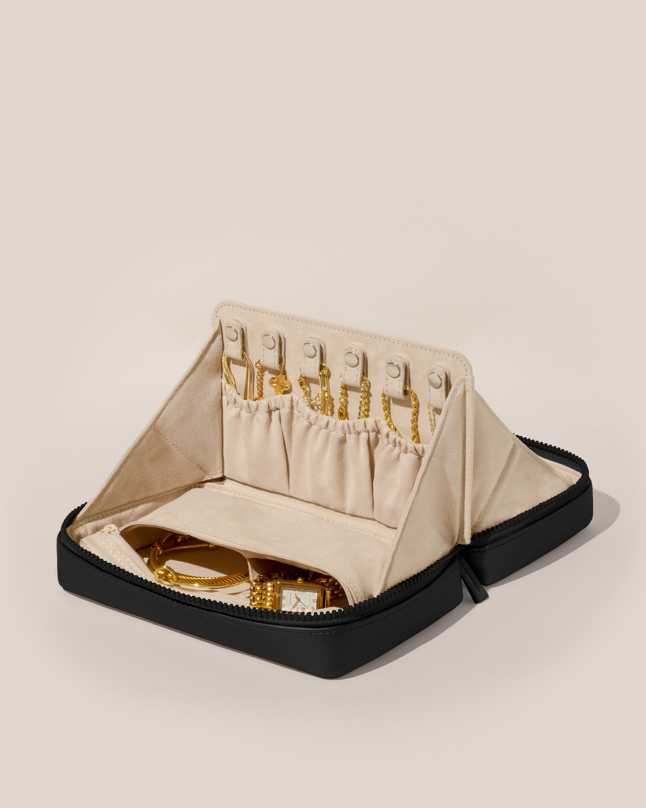 Open Parallelle Onyx (Black) Vault, shown open and packed with necklaces in dedicated necklace pouches with snaps to keep them in place. Watches and bracelets are packed in a zipper pocket.