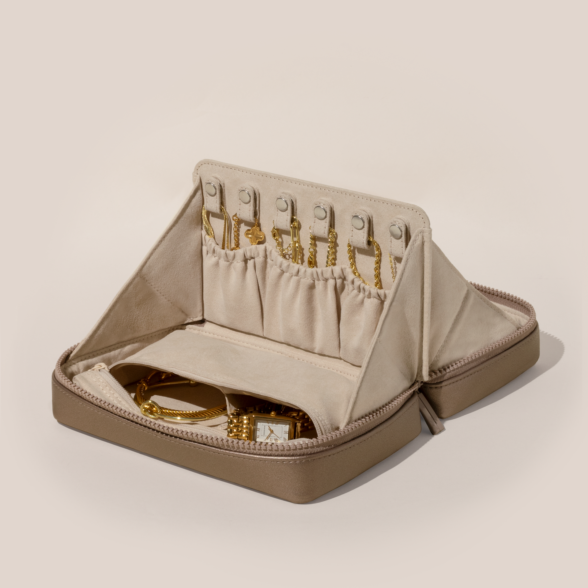 Open Parallelle Bronze Vault, shown open and packed with necklaces in dedicated necklace pouches with snaps to keep them in place. Watches and bracelets are packed in a zipper pocket.