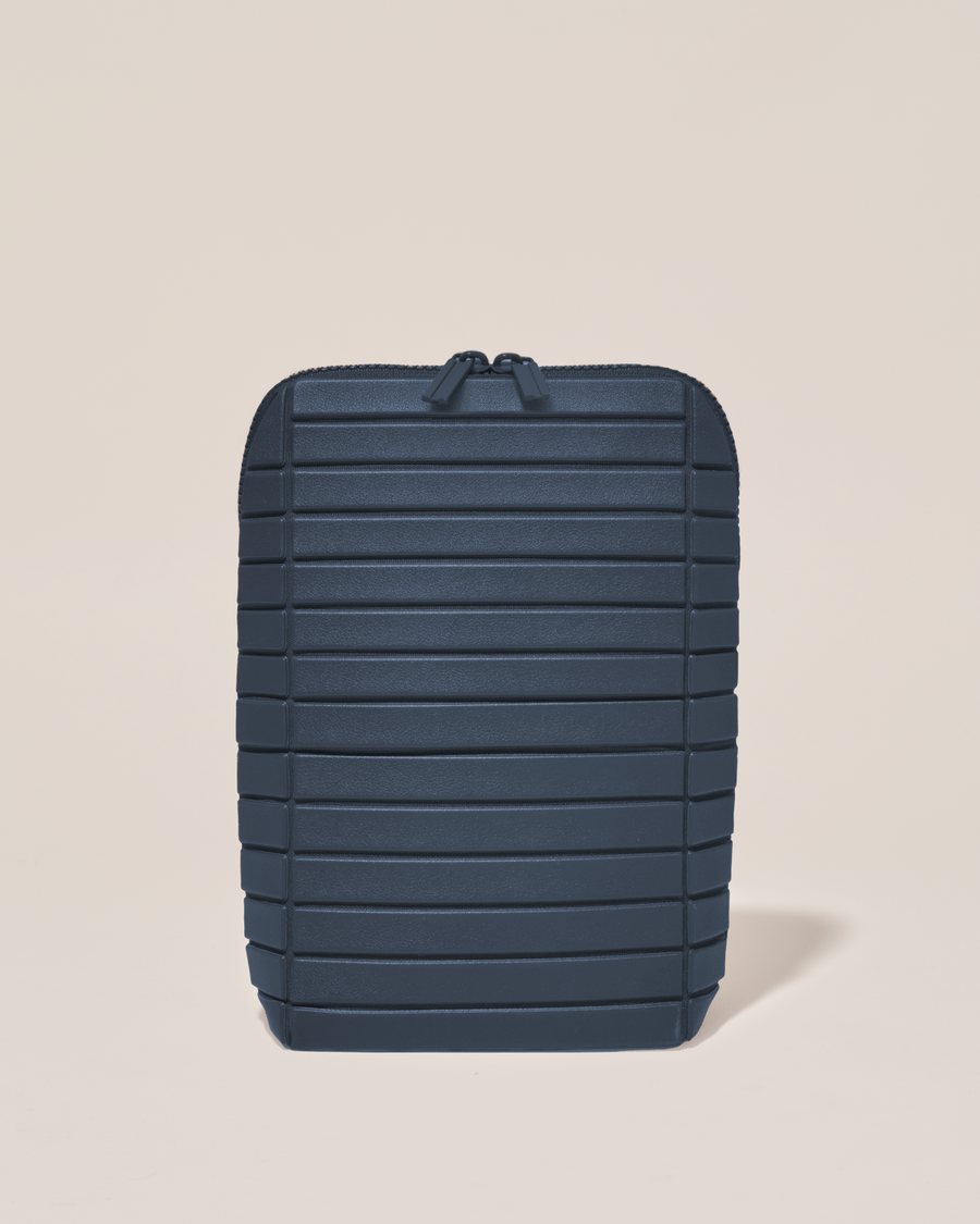 Closed Parallelle Indigo (navy) Brush Traveller makeup bag with structured horizontal bar design