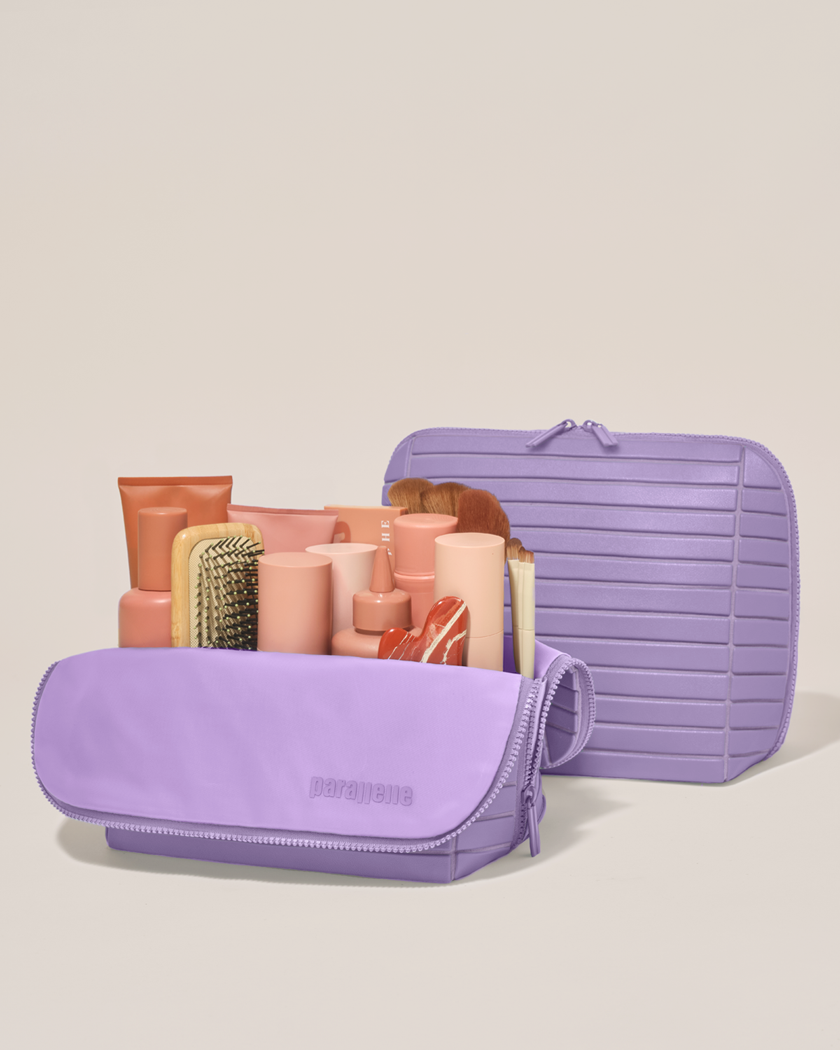 Open and closed Parallelle Large Lilac (purple) Traveller makeup bag showing skincare, brushes, and curated travel essentials