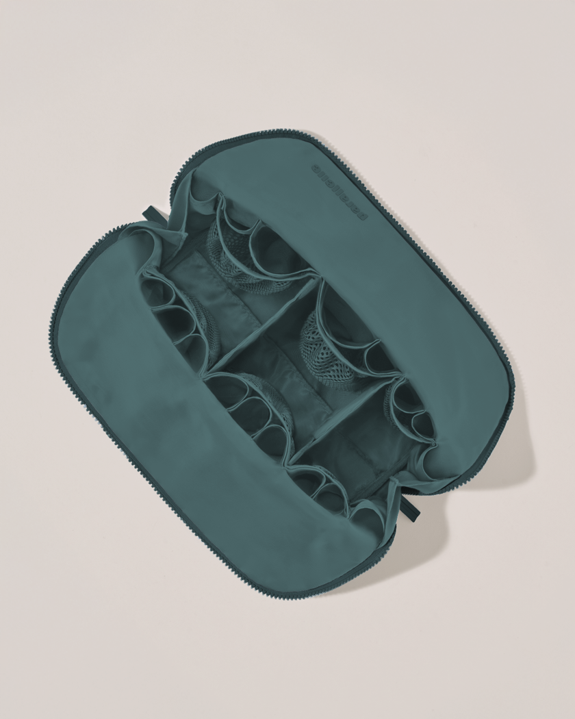 Interior view of Parallelle Large Spruce (green) Traveller makeup bag showing empty pockets, pouches, and elastic holders