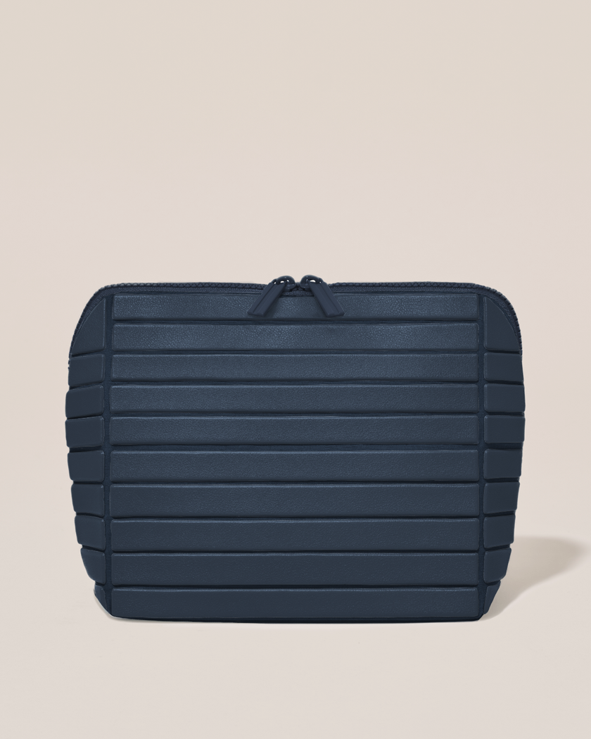 Closed Parallelle Medium Indigo (navy) Traveller makeup bag with structured horizontal bar design