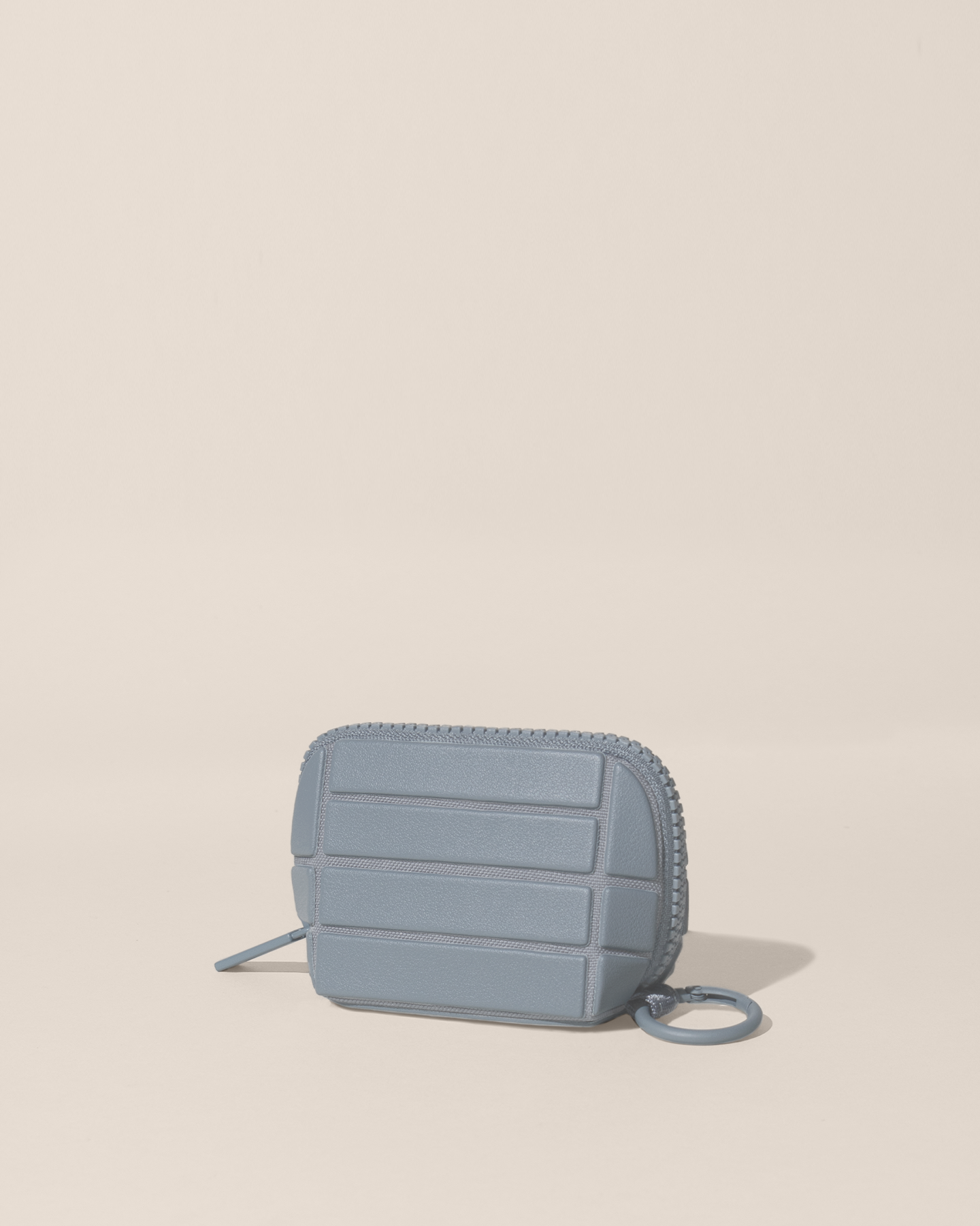 Closed Parallelle Slate (blue) Traveller Keychain with structured horizontal bar design shown from the side