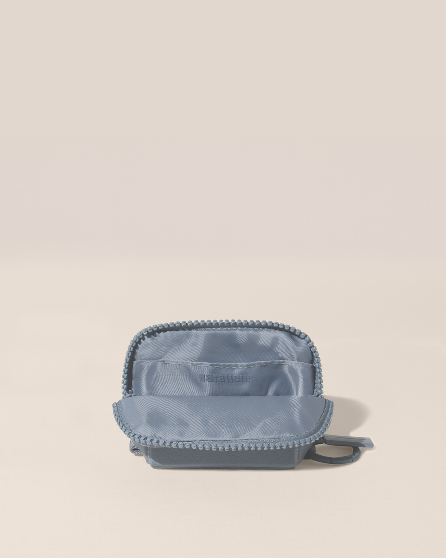 Open view of the Parallelle Slate (blue) Traveller Keychain showing the interior, which is perfect for holding small essentials