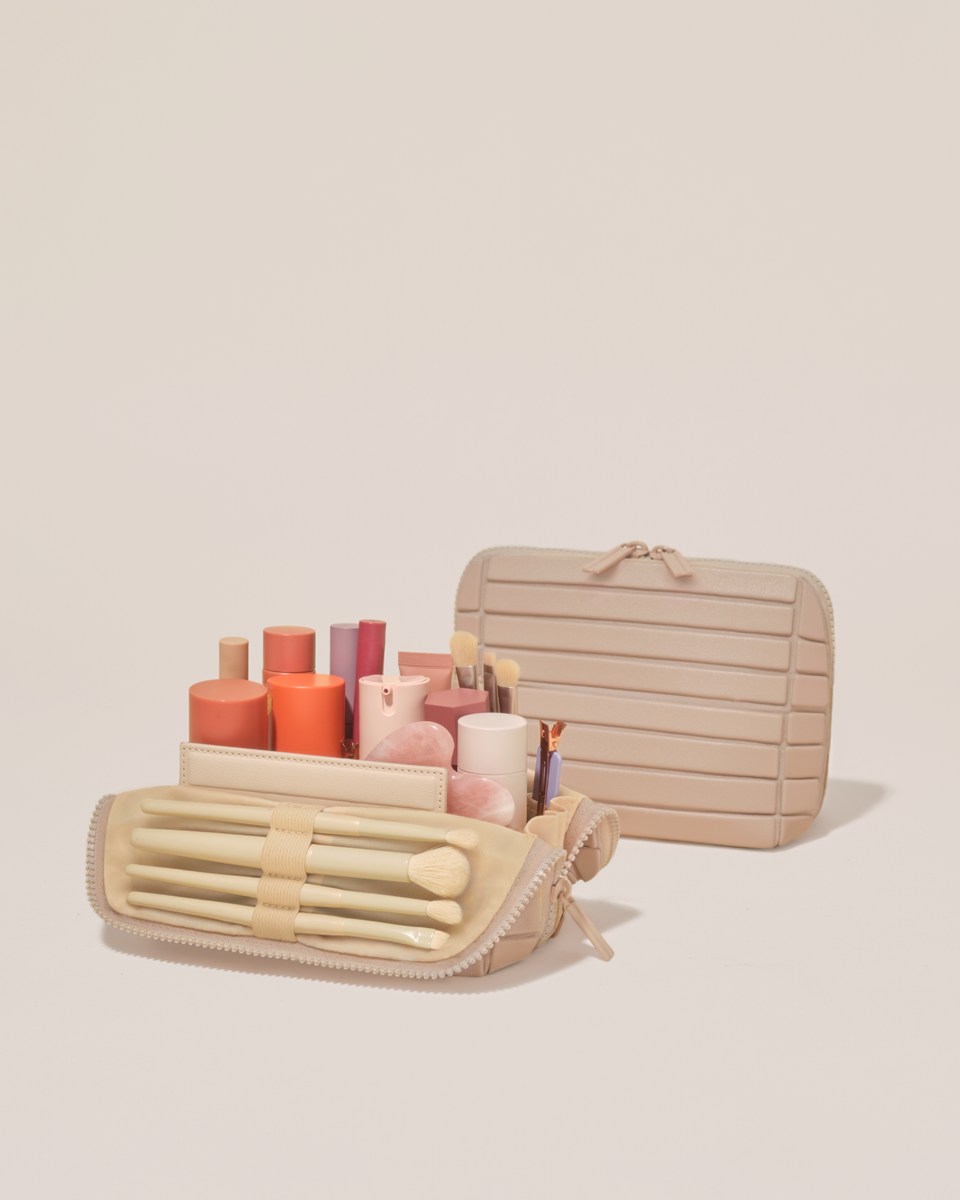 Open and closed Parallelle Small Bisque (white) Traveller makeup bag showing skincare, brushes, and curated travel essentials