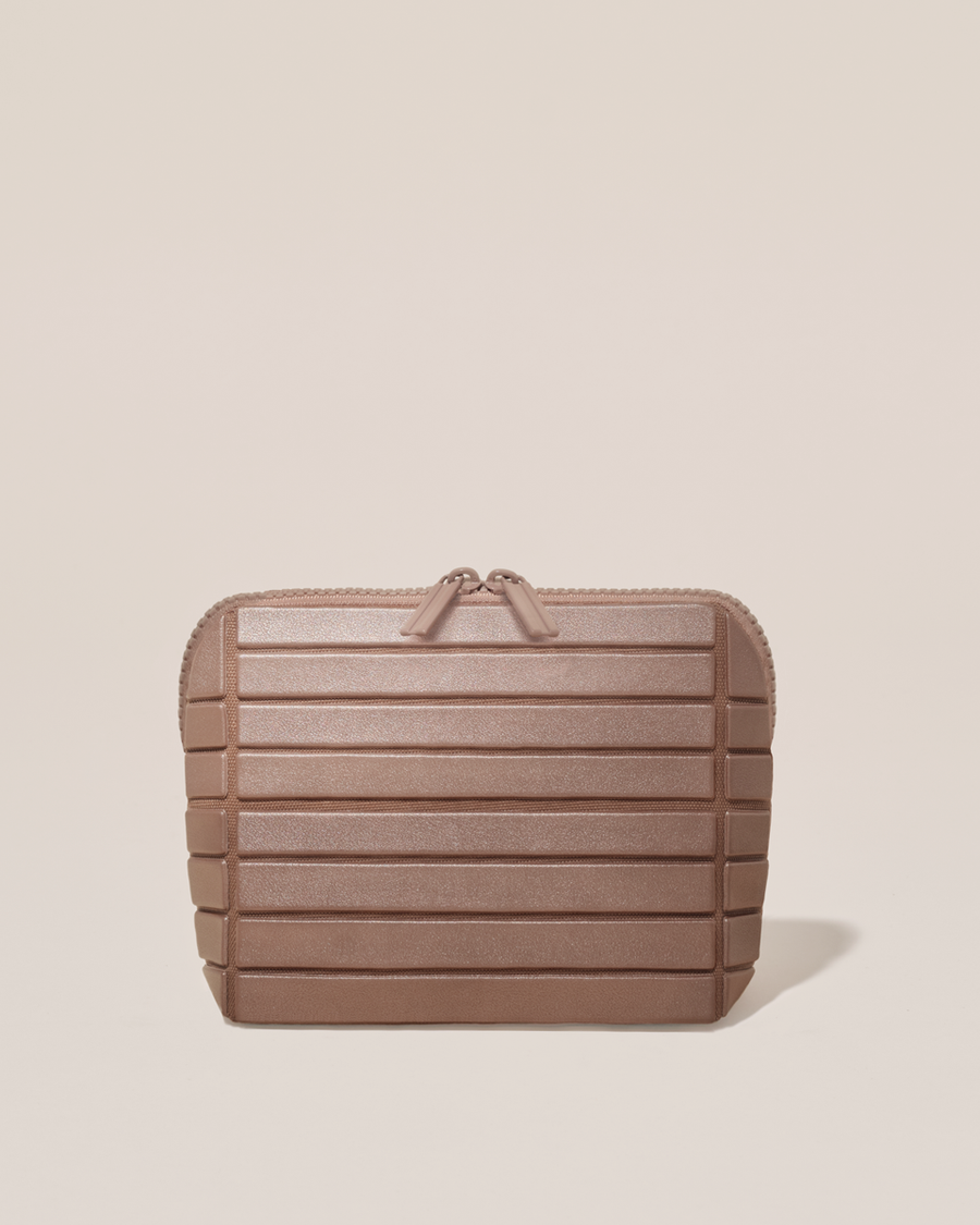 Closed Parallelle Small Bronze Traveller makeup bag with structured horizontal bar design
