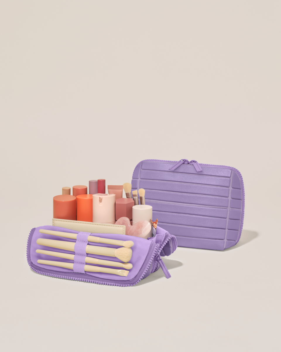 Open and closed Parallelle Small Lilac (purple) Traveller makeup bag showing skincare, brushes, and curated travel essentials