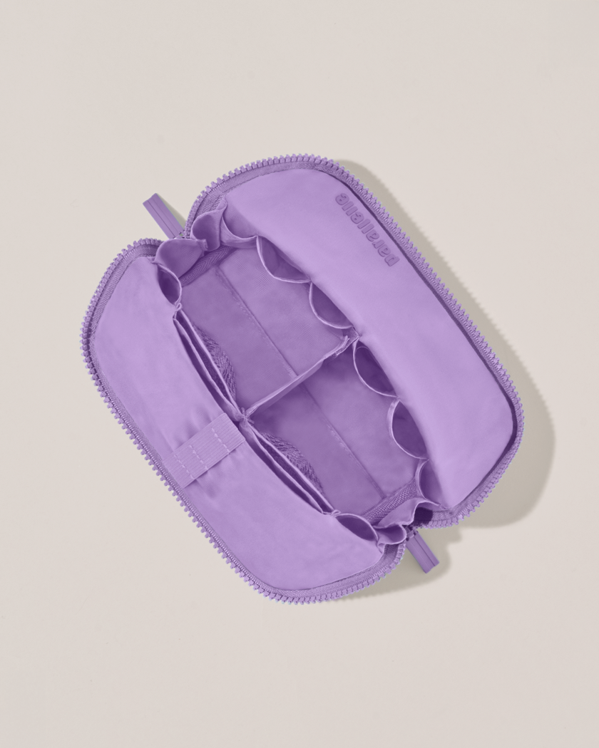 Interior view of Parallelle Small Lilac (purple) Traveller makeup bag showing empty pockets, pouches, and elastic holders