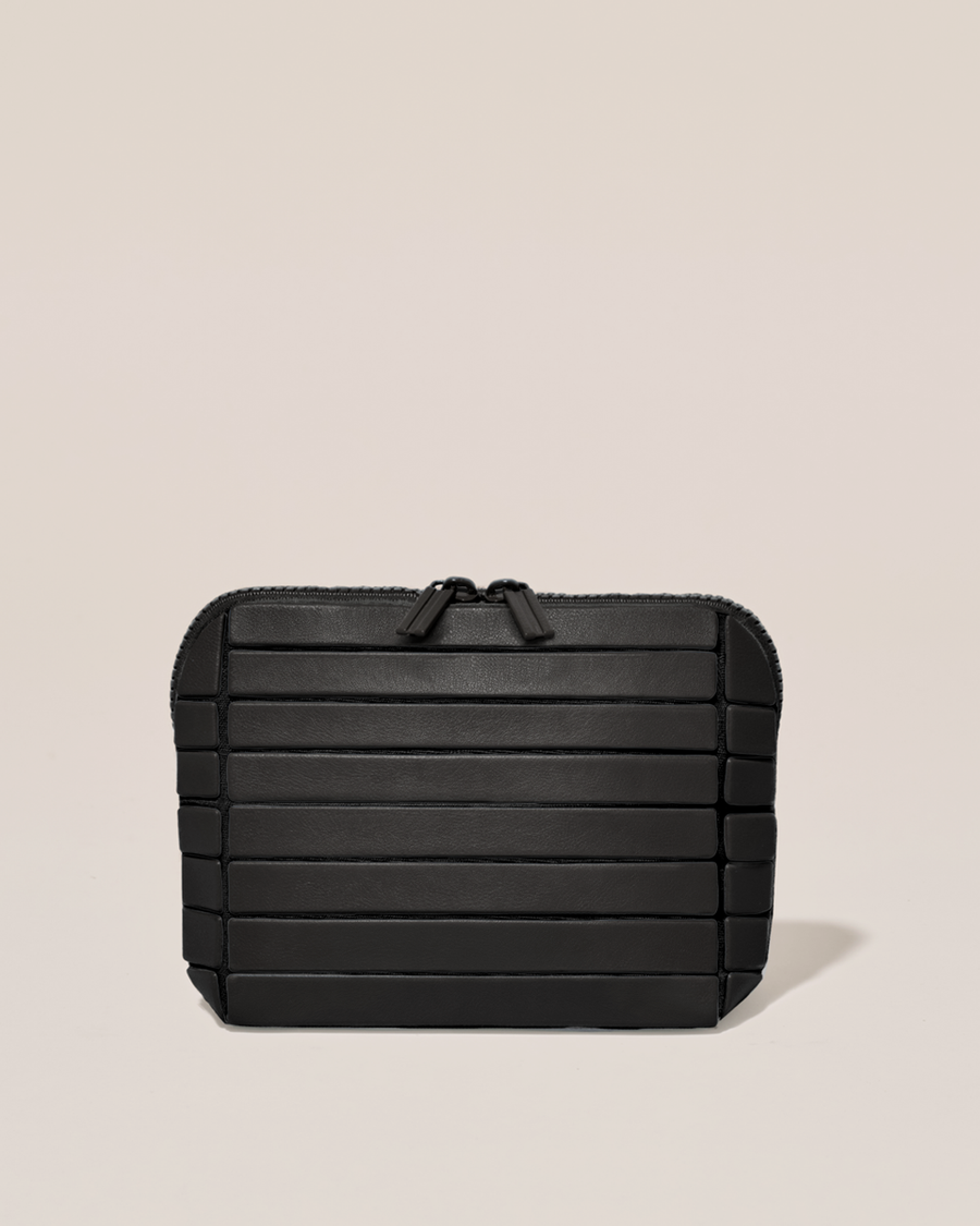Closed Parallelle Small Onyx (black) Traveller makeup bag with structured horizontal bar design