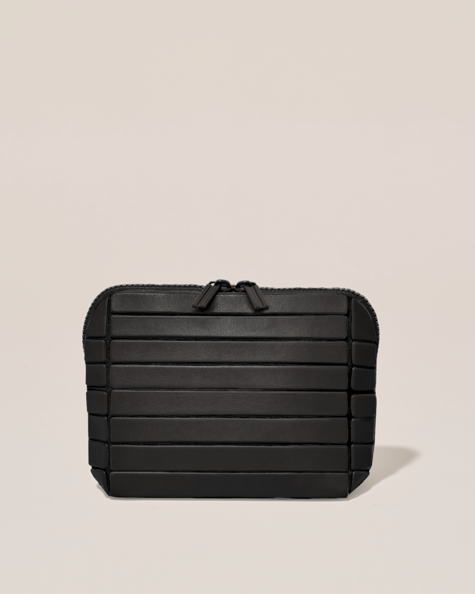 Closed Parallelle Small Onyx (black) Traveller makeup bag with structured horizontal bar design