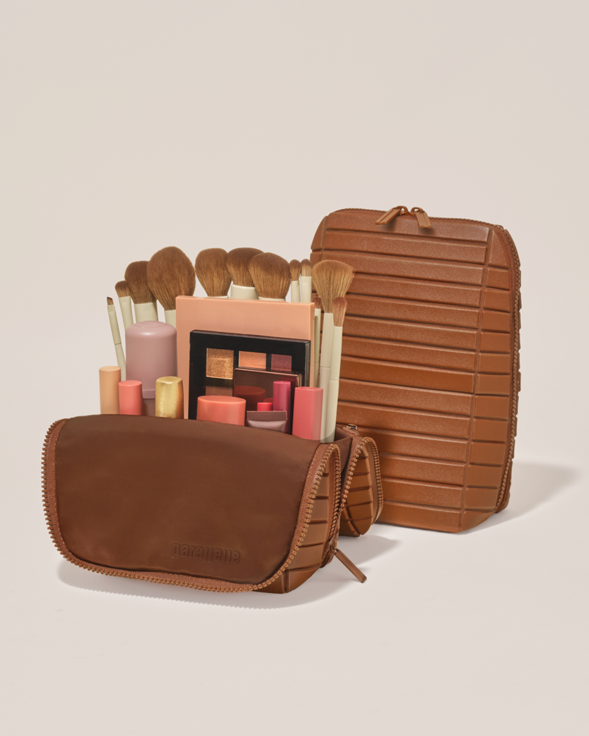 Open and closed Parallelle Vicuna (brown) Brush Traveller makeup bag showing skincare, brushes, and curated travel essentials