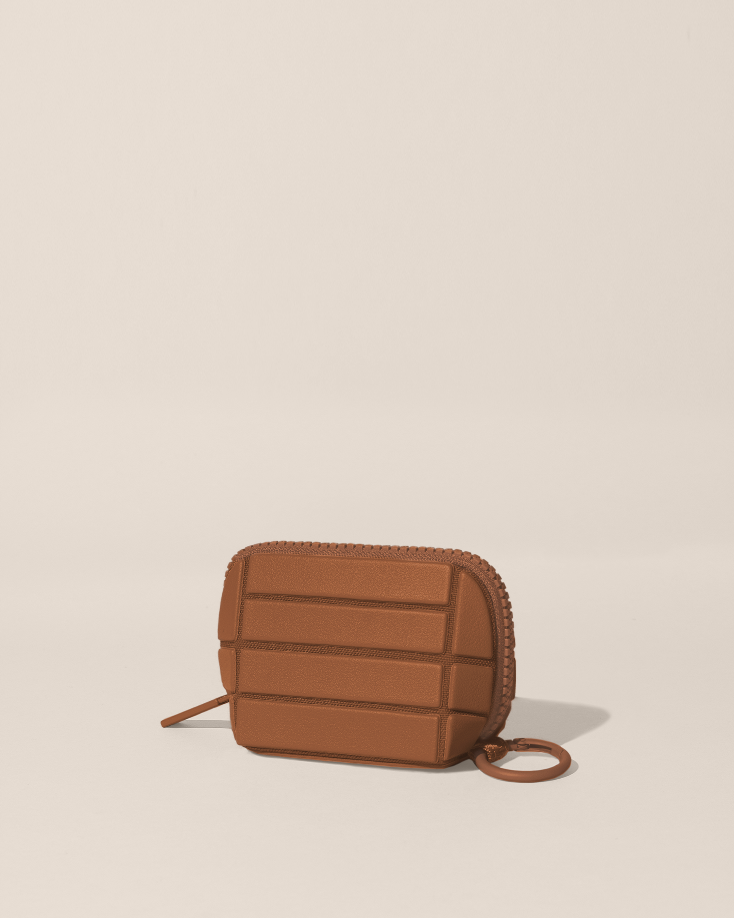 Closed Parallelle Vicuna (brown) Traveller Keychain with structured horizontal bar design shown from the side