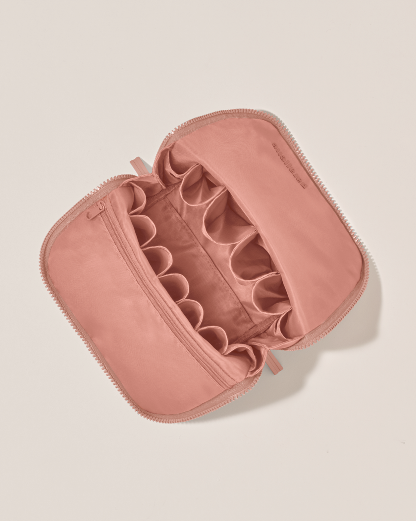 Interior view of Parallelle Blush (pink) Brush Traveller makeup bag showing empty pockets and pouches