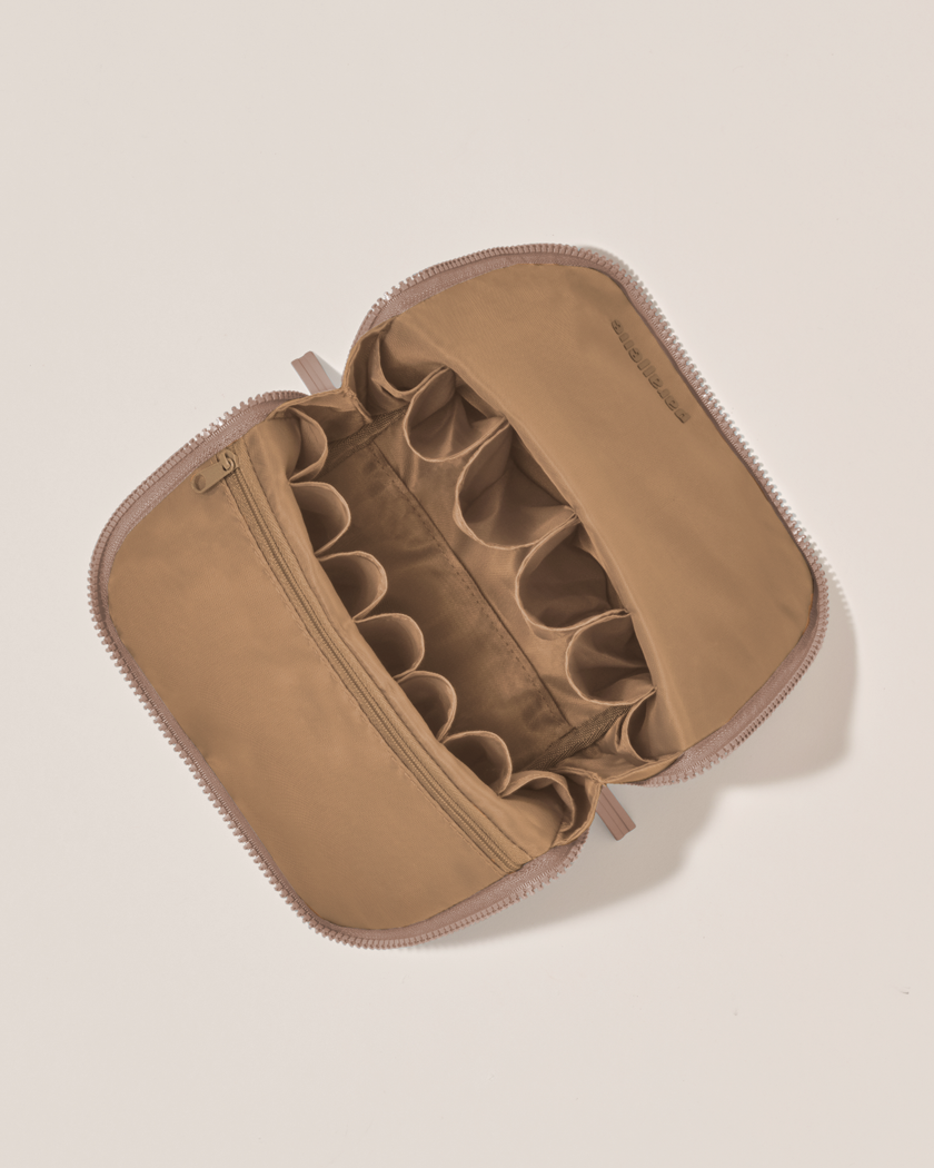 Interior view of Parallelle Bronze Brush Traveller makeup bag showing empty pockets and pouches