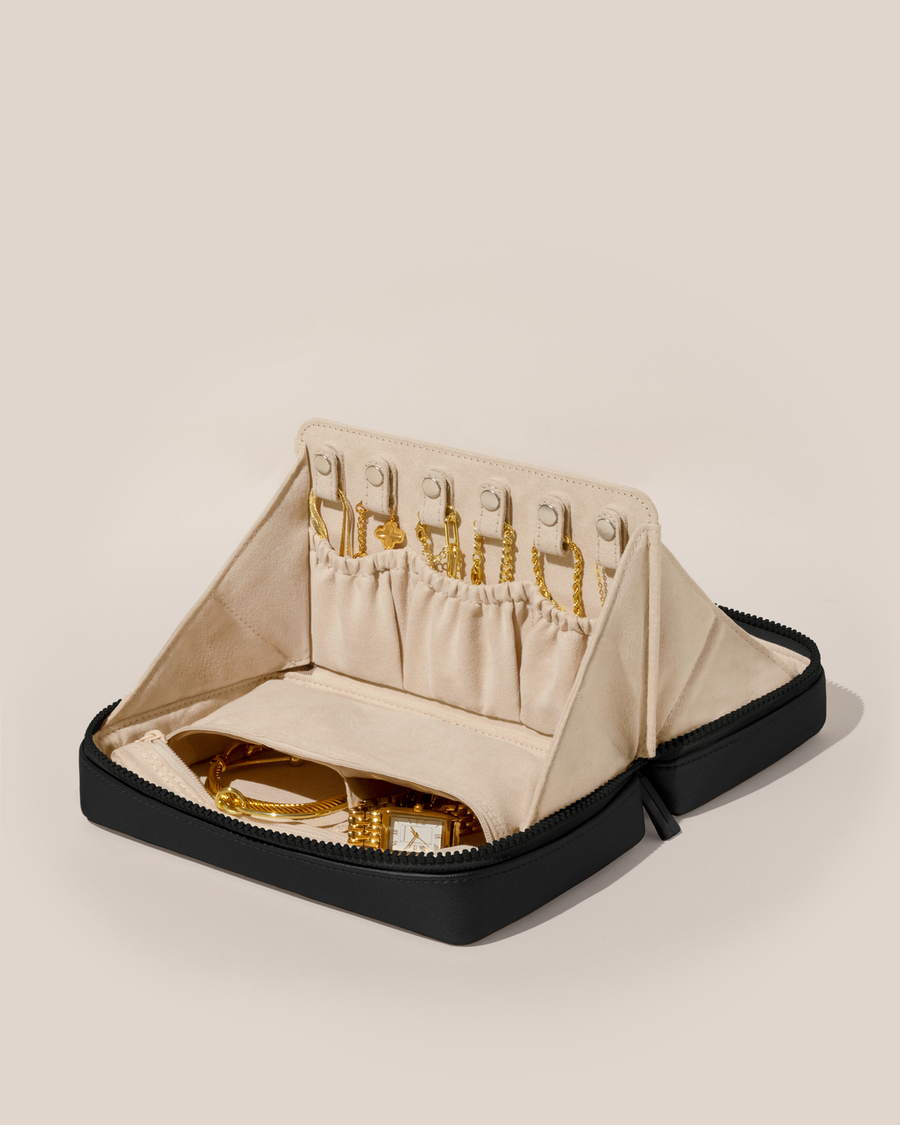 Open Parallelle Onyx (Black) Vault, shown open and packed with necklaces in dedicated necklace pouches with snaps to keep them in place. Watches and bracelets are packed in a zipper pocket.