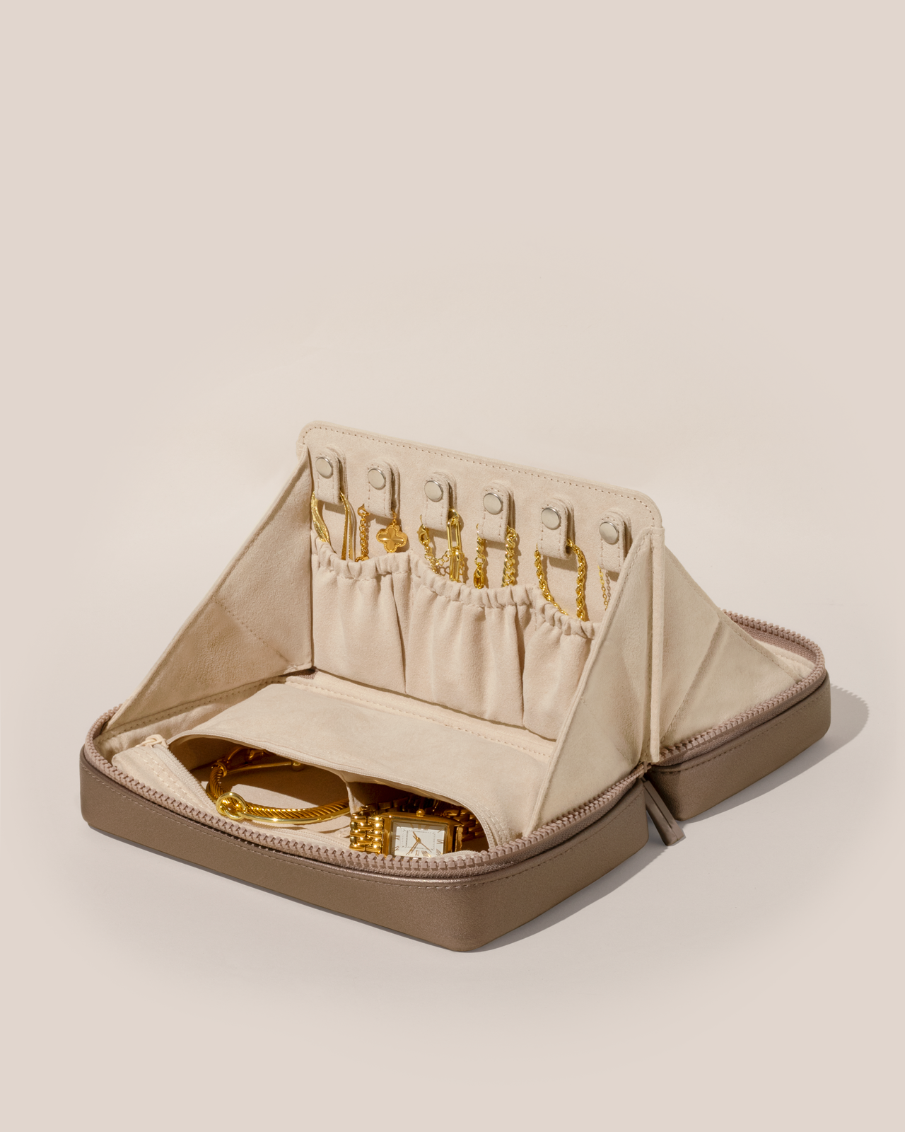 Open Parallelle Bronze Vault, shown open and packed with necklaces in dedicated necklace pouches with snaps to keep them in place. Watches and bracelets are packed in a zipper pocket.