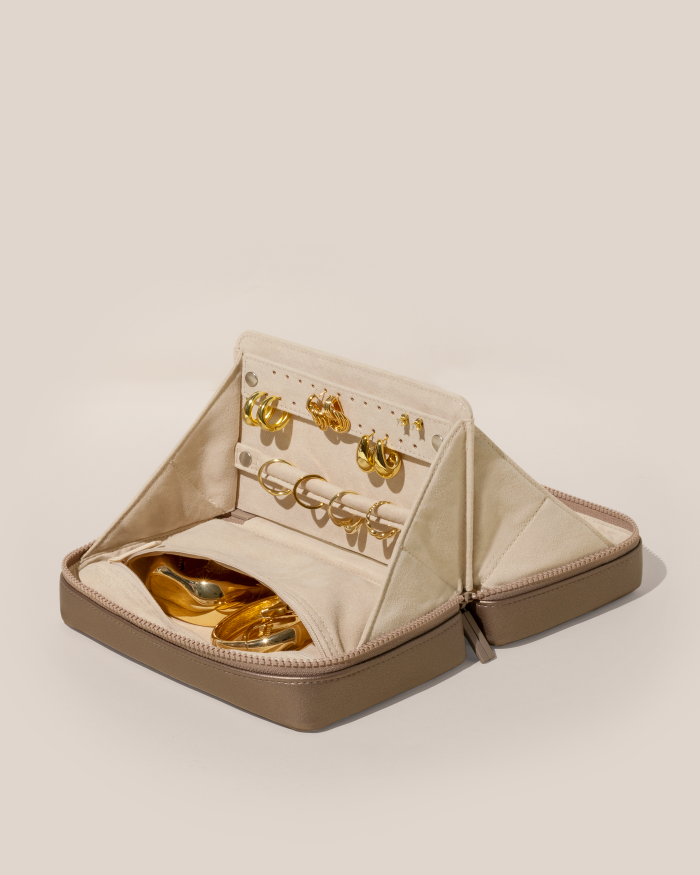 Open Parallelle Bronze Vault, shown open and packed with rings and earrings on respective removable ring and earring bars. Watches and bracelets are packed in a zipper pocket.