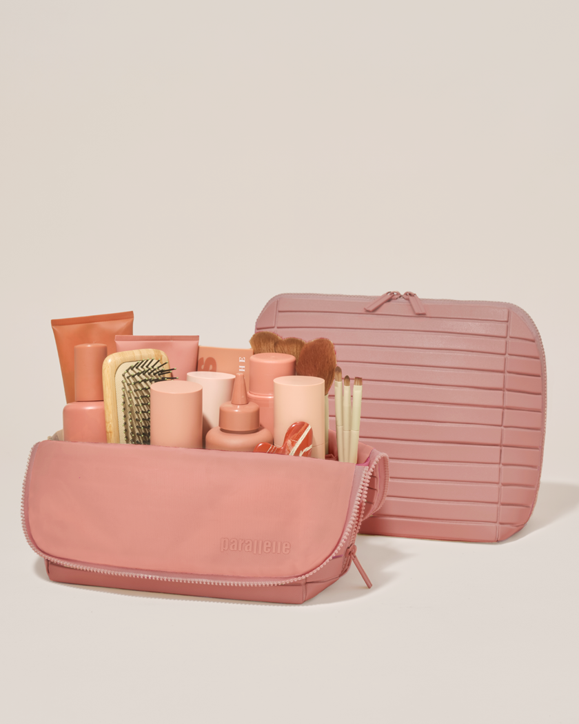 Open and closed Parallelle Large Blush (pink) Traveller makeup bag showing skincare, brushes, and curated travel essentials
