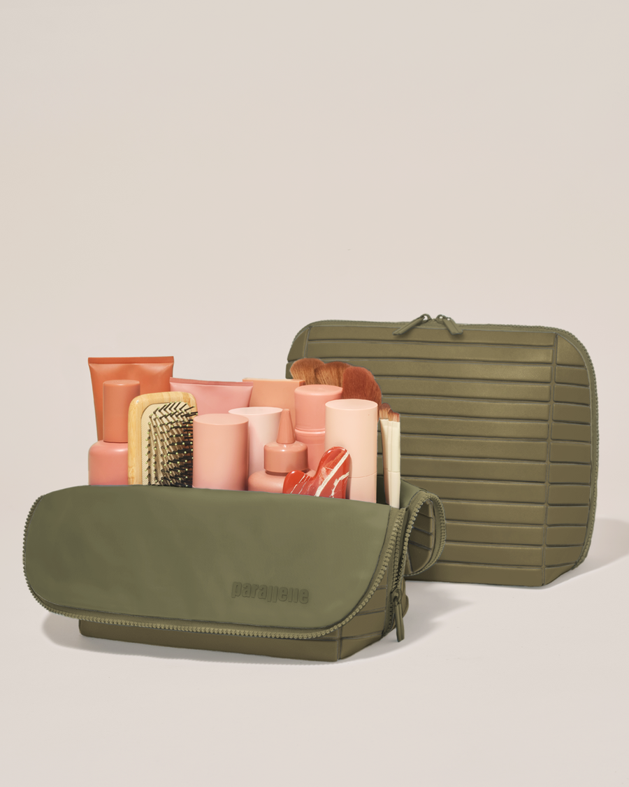 Open and closed Parallelle Large Olive (green) Traveller makeup bag showing skincare, brushes, and curated travel essentials