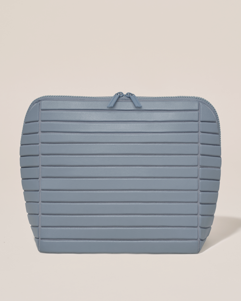 Closed Parallelle Large Slate (blue) Traveller makeup bag with structured horizontal bar design