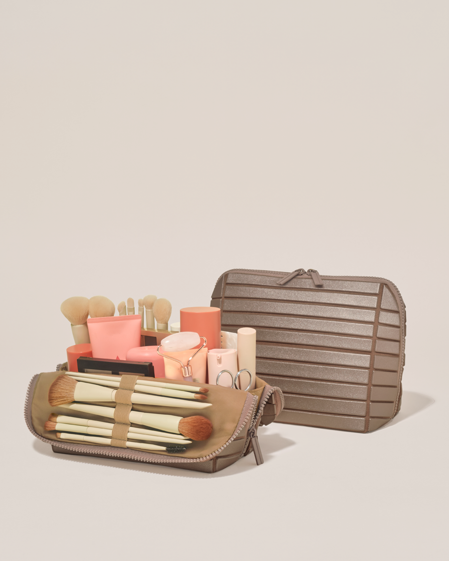 Open and closed Parallelle Medium Bronze Traveller makeup bag showing skincare, brushes, and curated travel essentials