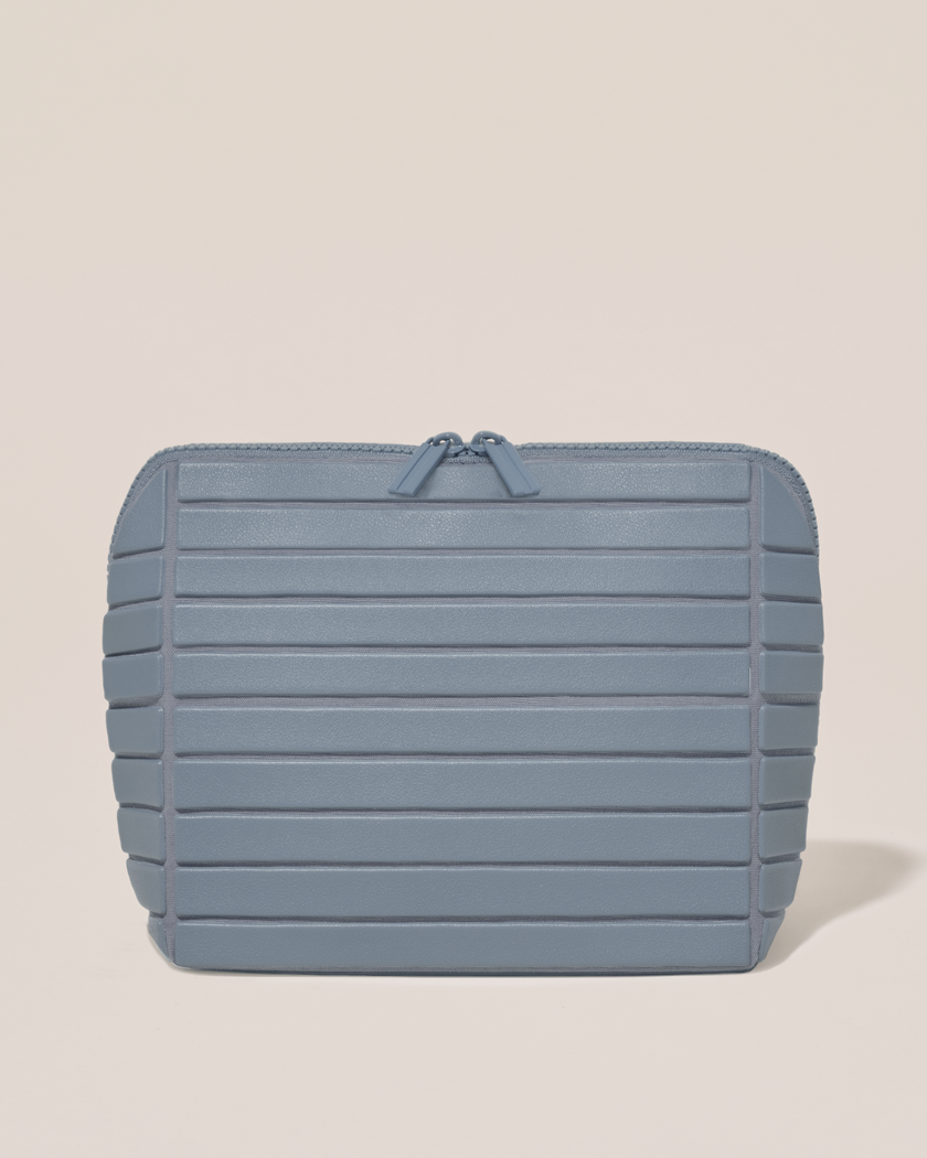 Closed Parallelle Medium Slate (blue) Traveller makeup bag with structured horizontal bar design