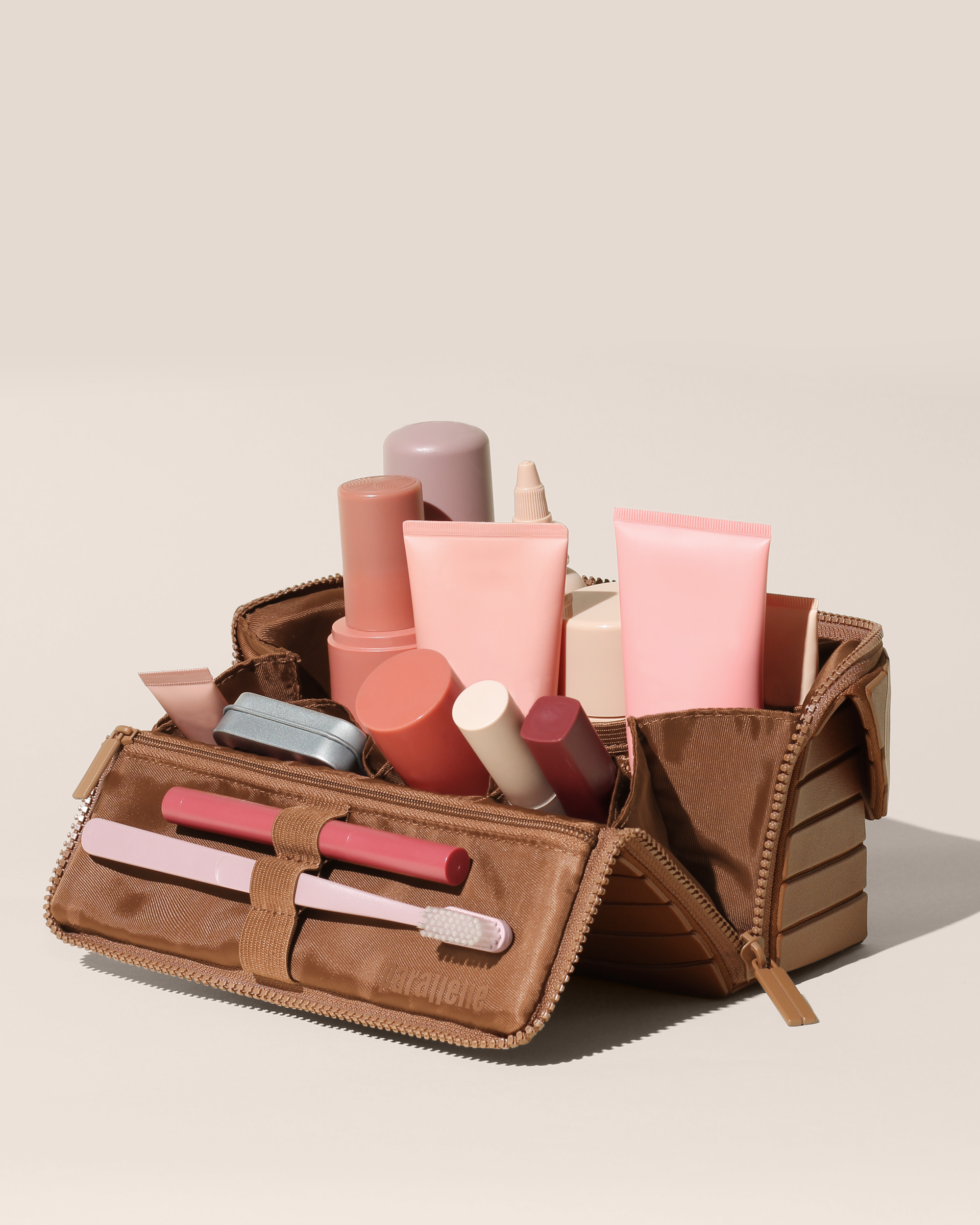 Open Parallelle Medum Vicuna (brown) Kit, shown open and packed with skincare and grooming products and expanded using its accordion opening