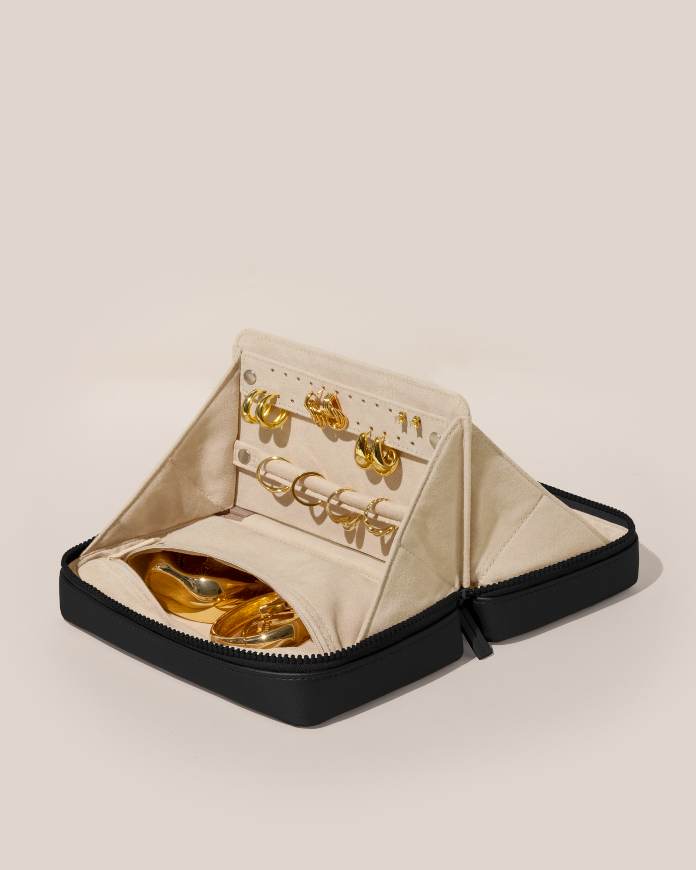 Open Parallelle Onyx (black) Vault, shown open and packed with rings and earrings on respective removable ring and earring bars. Watches and bracelets are packed in a zipper pocket.