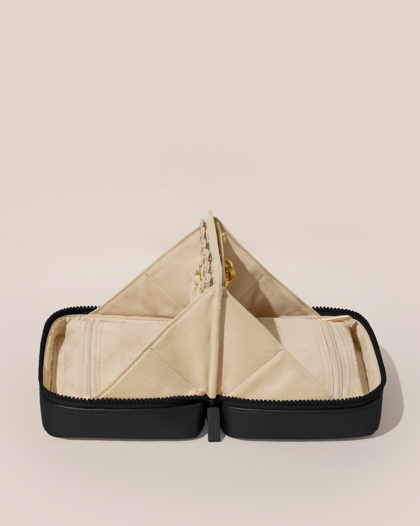 Open Parallelle Onyx (Black) Vault, shown open and from the side, with one side for rings and earrings and the other for necklaces. Both sides have a zipper pocket for watches and bracelets.