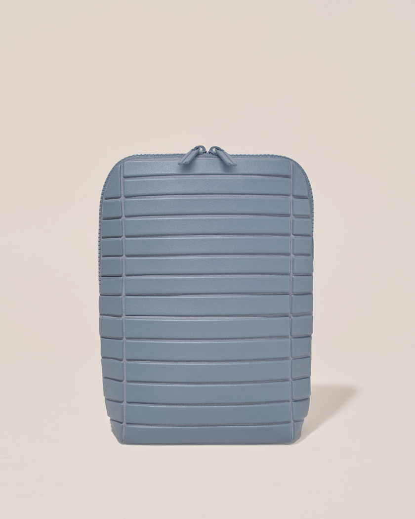 Closed Parallelle Slate (blue) Brush Traveller makeup bag with structured horizontal bar design