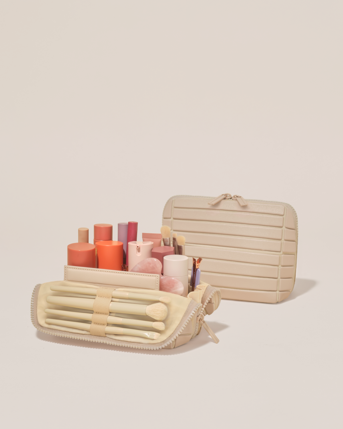 Open and closed Parallelle Small Bisque (white) Traveller makeup bag showing skincare, brushes, and curated travel essentials