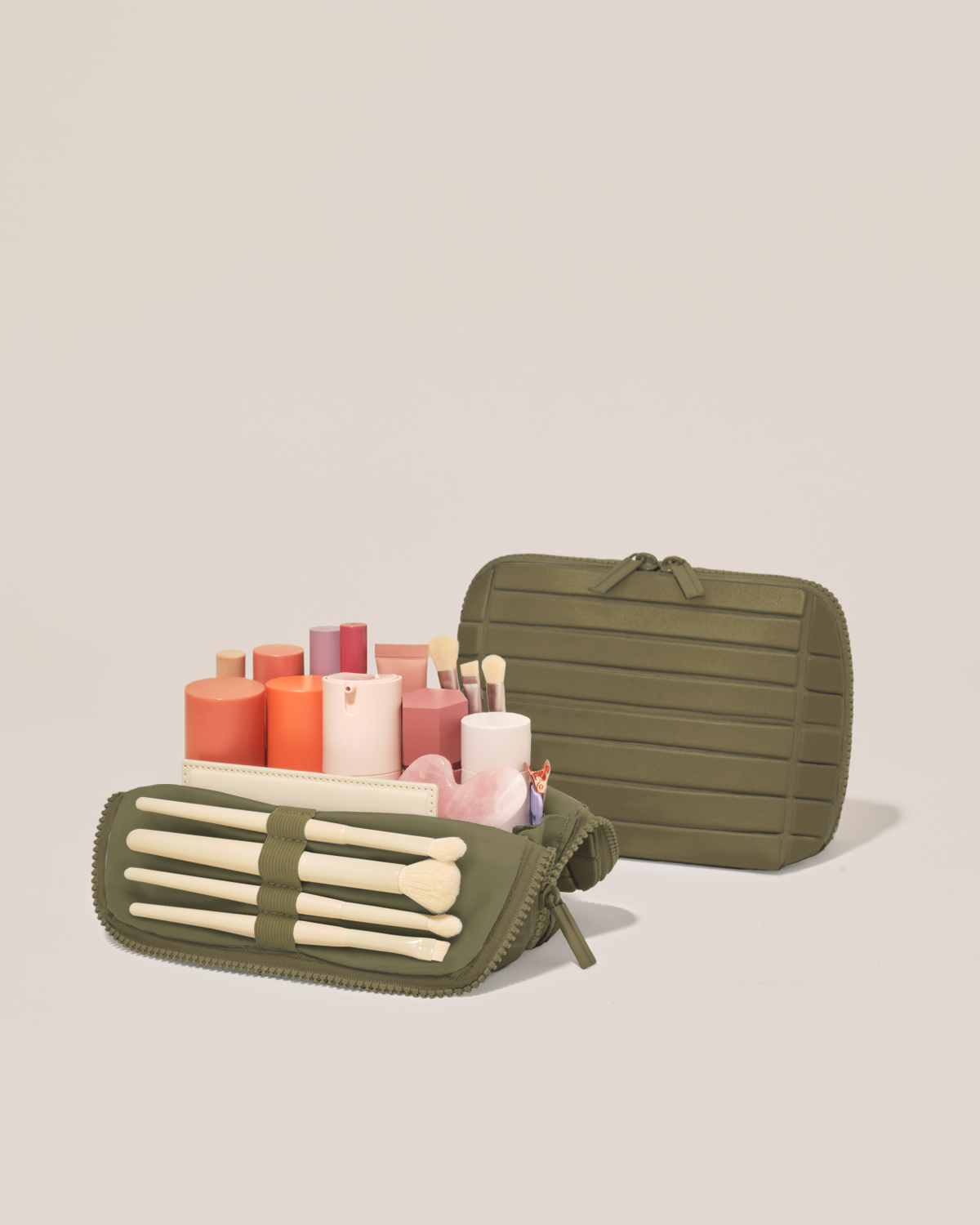 Open and closed Parallelle Small Olive (green) Traveller makeup bag showing skincare, brushes, and curated travel essentials