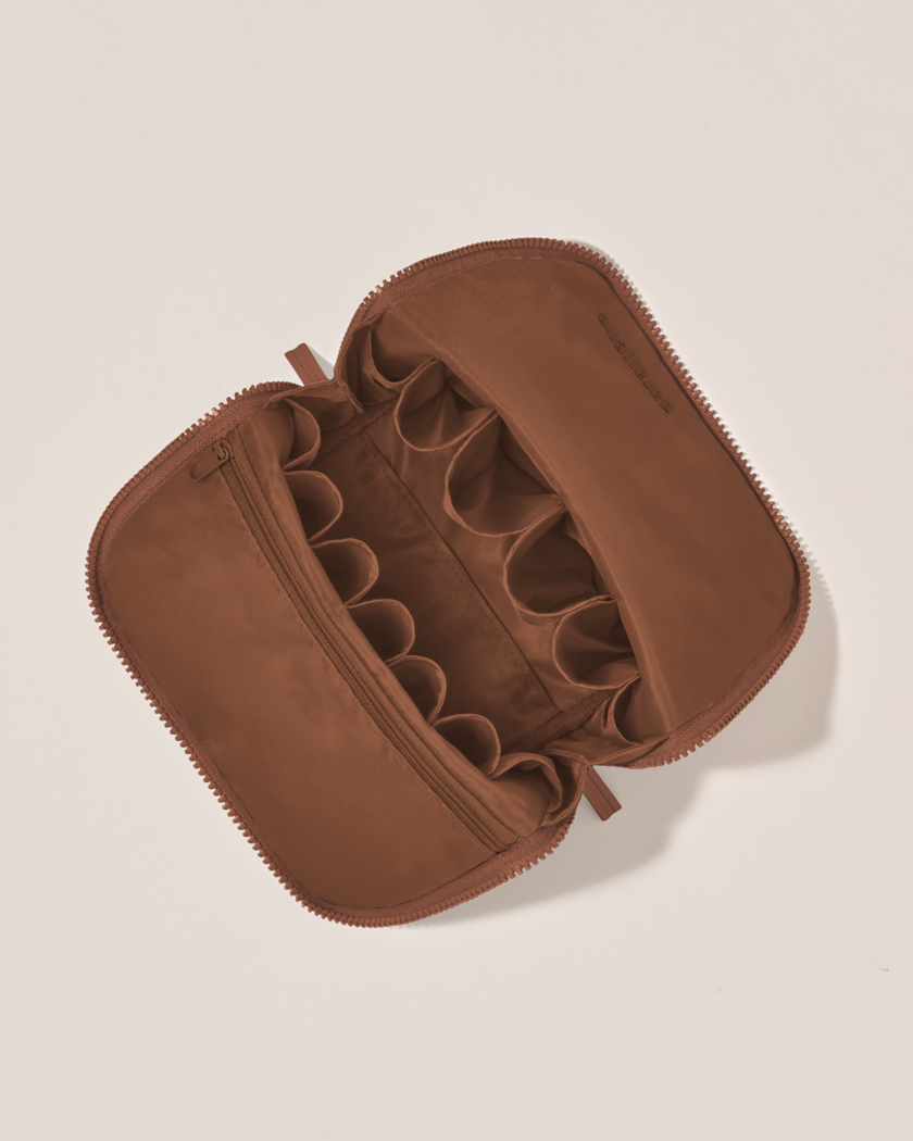Interior view of Parallelle Vicuna (brown) Brush Traveller makeup bag showing empty pockets and pouches