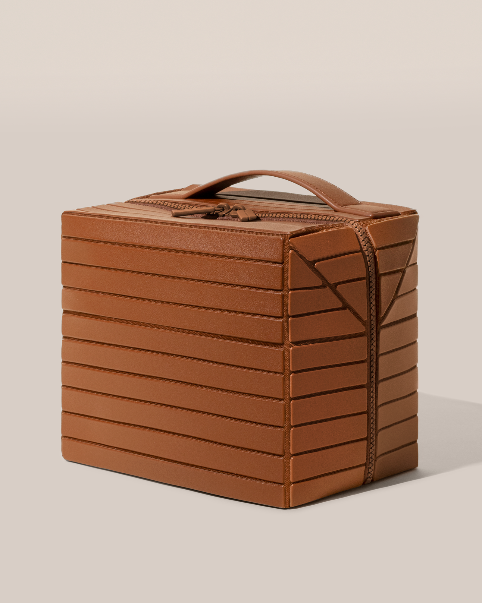 Closed Parallelle Vicuna (brown) Kit toiletry bag with a compact, zip-around design and top handle for elevated everyday or travel organization