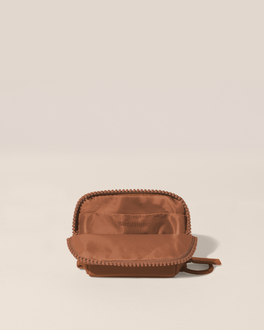 Open view of the Parallelle Vicuna (brown) Traveller Keychain showing the interior, which is perfect for holding small essentials